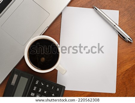 empty paper , pen and cup of coffee on wooden table