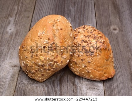 Bread with seeds on wooden background