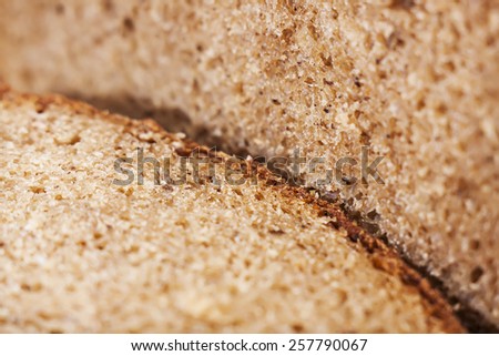 fresh brown bread with bran, cut into pieces, close-up, texture of bread