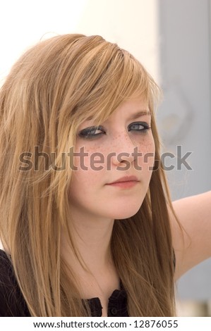 stock photo Pretty blond teen girl looks into the camera looking almost 