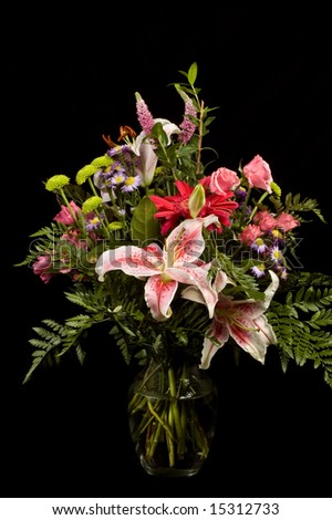 Lily floral arrangement shot in the studio against black.