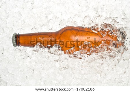 Close-up of the neck of an ice cold beer, resting in crushed ice.