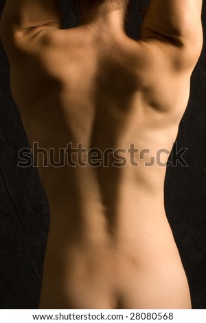stock photo Abstract image of a nude female back in color against black 