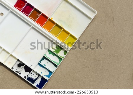 palette of watercolor paints with brush