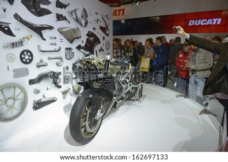 MILAN, ITALY - NOVEMBER 8: People visit Ducati motorcycles and scooters exhibition area at EICMA, 71st International Motorcycle Exhibition on November 8, 2013 in Milan, Italy.