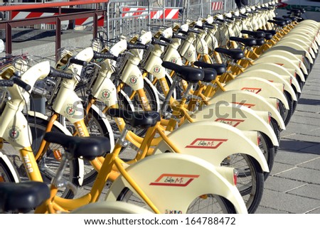 MILAN, ITALY - NOVEMBER 27: yellow BikeMi bicycles for rent in a parking spot, November 27, 2013 in Milan, Italy.