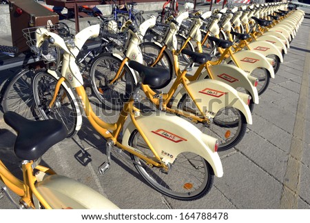 MILAN, ITALY - NOVEMBER 27: yellow BikeMi bicycles for rent in a parking spot, November 27, 2013 in Milan, Italy.