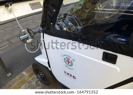 MILAN, ITALY - NOVEMBER 27: public electric car recharging a parking spot, November 27, 2013 in Milan, Italy.