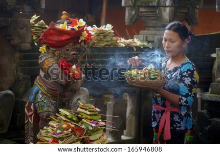 UBUD, BALI, INDONESIA - FEBRUARY,14: a woman offers flowers to goddess, on February,14, 2005 in Ubud, Bali, Indonesia.