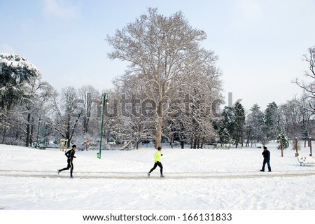 MILAN, ITALY - FEBRUARY, 02: people jogging in a public park covered with snow, in Milan. Milan, February 02,2012