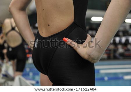 MILAN, ITALY - MAY 10: A swimmer woman with red nails ready at the starting blocks, during a competition in Milan May 10, 2009.