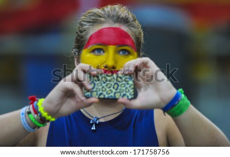 MILAN, ITALY - AUGUST 31: a spanish woman fan taking picture with a smartphone during the American Football European Championship match Italy vs Spain in Milan AUGUST 31, 2013.
