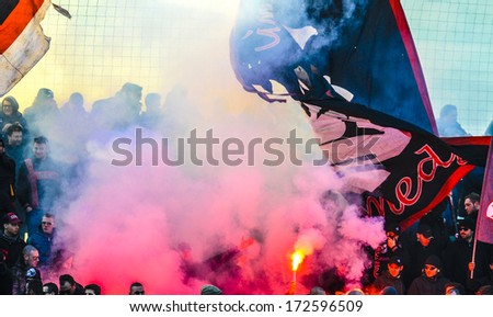 MILAN, ITALY - JANUARY 12: AC Milan soccer fans with flags and smokes bomb supporting AC Milan youth team in Milan January 12, 2014.