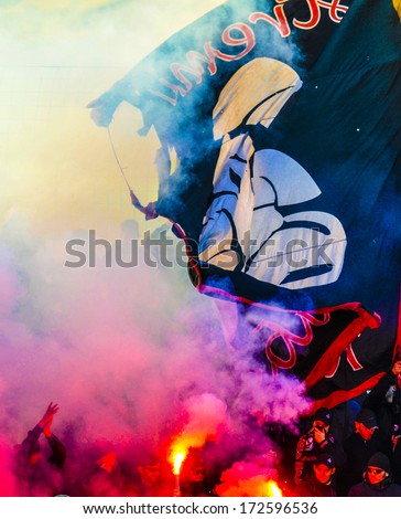 MILAN, ITALY - JANUARY 12: AC Milan soccer fans with flags and smokes bomb supporting AC Milan youth team in Milan January 12, 2014.