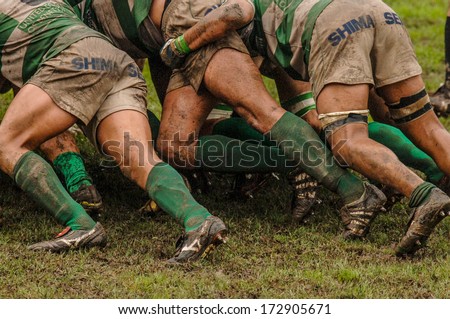 PARMA, ITALY - OCTOBER 12: Close up of rugby players muddy legs pushing in a scrum during the Italian Rugby League match Parma vs Treviso, in Parma, October 12, 2005.