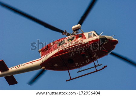 MILAN, ITALY - OCTOBER 13: Fire fighter rescue helicopter flying, with a blue sky in the background, in Milan October 13, 2005.