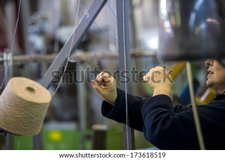 BRESCIA, ITALY - DECEMBER 06: Woman hands working in a knitwear factory in Brescia, December 06, 2011.