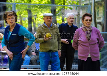 MILAN ITALY APRIL 12 Elderly man and women playing bocce together in an outdoor park in Milan April 12 2011 MILAN ITALY APRIL 12 Elderly man and women playing bocce together in an outdoor park in Milan April 12 2011