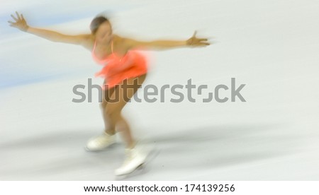 TURIN, ITALY - FEBRUARY 22, 2006: Blurry athlete performs during the Winter Olympics female\'s competition of the Figure Ice Skating.