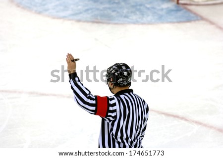 TURIN, ITALY-FEBRUARY 18, 2006: Ice Hockey referee with the Olympic rings on the background, at the Winter Olympic Games of Turin 2006.