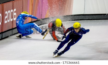 TURIN, ITALY FEBRUARY 16, 2006: Athletes group falling during the Short Track competition at the Winter Olympic Games of Turin 2006.