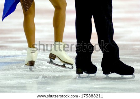 TURIN, ITALY-FEBRUARY 21, 2006: Skates close up of a couple competing on the Figure Ice Skating competition, at the Winter Olympic Games of Turin 2006.