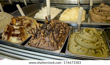 Pistachio ice cream and cream flavors are shown inside an italian ice cream parlor.