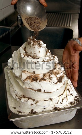 Ice cream maker topping chocolate.