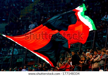 MILAN,ITALY-APRIL 20,2006: AC Milan soccer fans waving the red and black team flag.