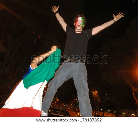MILAN, ITALY-JULY 05, 2006: Italian soccer fans celebrating at night on the streets of Milan the Italian win of the soccer World Cup of Germany 2006.