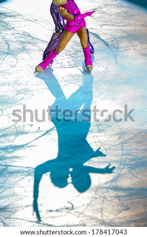 MILAN, ITALY-OCTOBER 11, 2008: Shadow on ice of a figure ice skaters couple competing on the Ice Christmas Gala at the Forum arena of Milan.