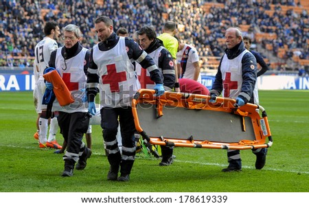 MILAN, ITALY-FEBRUARY 23, 2014: Red cross volunteers with gurney on the soccer pitch, during the Italian Serie A soccer match FC Internazionale vs Cagliari at  the San Siro stadium.
