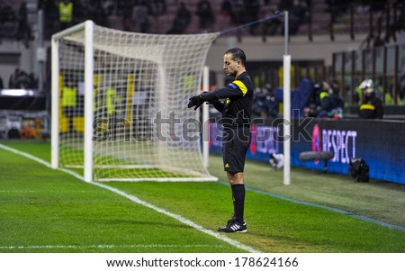 MILAN, ITALY-FEBRUARY 19, 2014: Linesman or fifth man checking the time at the start of the soccer UEFA Champions League match AC Milan vs Athletic Madrid, at  the San Siro stadium.