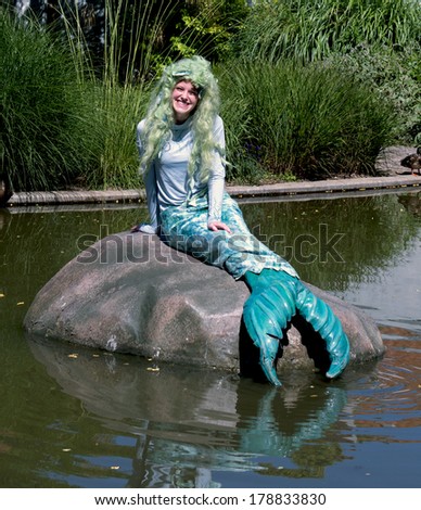 ODENSE, DENMARK-FEBRUARY 16, 2012: Young theater character playing the Mermaid role of the Hans Christian Andersen's fairytale, pose at the amusement park family of the writer museum.
