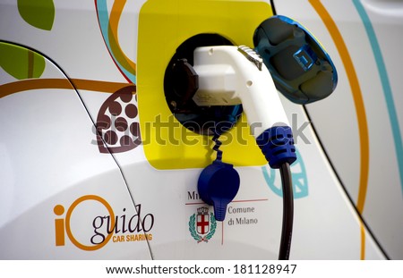 MILAN, ITALY-FEBRUARY, 23, 2012: Electric car recharging the battery on a car sharing dedicated parking spot, in downtown Milan.