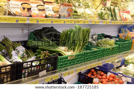 VARESE, ITALY-APRIL 11, 2014: Vegetables and packaged food in a supermarket shelve, in Varese.