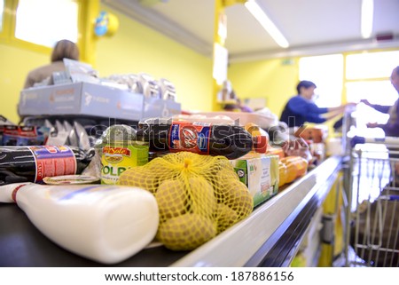 VARESE, ITALY-APRIL 11, 2014: Shopping to pay at the cash registers, in a supermarket in Varese.