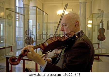 CREMONA, ITALY-JANUARY 13, 2012: Andrea Mosconi, curator of the world most famous collection of string instruments, plays the Stradivari 1715 violin \