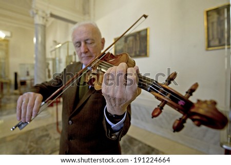 CREMONA, ITALY-JANUARY 13, 2012: Andrea Mosconi, curator of the world most famous collection of string instruments, plays the Stradivari 1715 violin 
