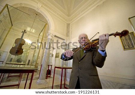 CREMONA, ITALY-JANUARY 13, 2012: Andrea Mosconi, curator of the world  most famous collection of string instruments, plays the Stradivari 1715 violin \