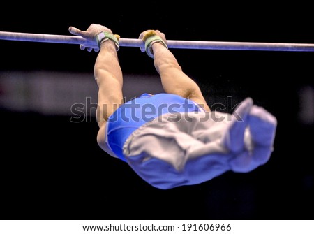 MILAN, ITALY-MARCH 31, 2008: a gymnast playing high bar exercise, during the European Artistic Gymnastic Championship, in Milan.