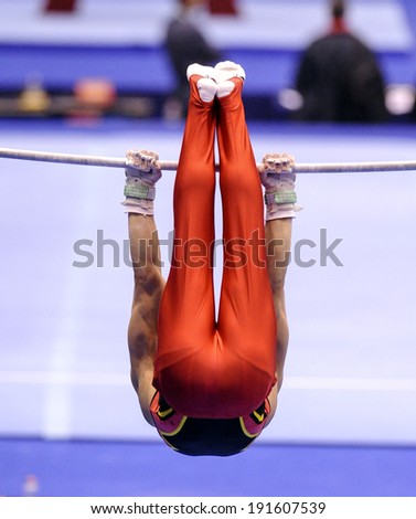 MILAN, ITALY-MARCH 31, 2008: a gymnast playing high bar exercise, during the European Artistic Gymnastic Championship, in Milan.