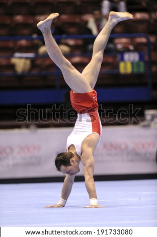 MILAN, ITALY-MARCH 31, 2008: a man athlete performs on gymnastic floor exercise, European Artistic Gymnastic Championship, in Milan.