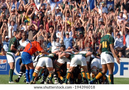 MARSEILLE, FRANCE-OCTOBER 07, 2007: rugby players scrum, with supporters cheering in the background, during the match Fiji vs South Africa, of the Rugby World Cup France 2007, in Marseille.