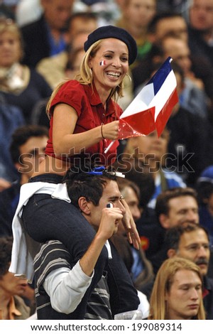 PARIS, FRANCE-SEPTEMBER 22, 2007: french fan girl cheering with national flags, during the Rugby World Cup match, Ireland vs France, in Paris.
