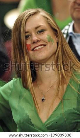 PARIS, FRANCE-SEPTEMBER 22, 2007: irish fan girl cheering with masked face, during the Rugby World Cup match, Ireland vs France, in Paris.
