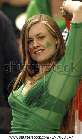 PARIS, FRANCE-SEPTEMBER 22, 2007: irish fan girl cheering with masked face, during the Rugby World Cup match, Ireland vs France, in Paris.