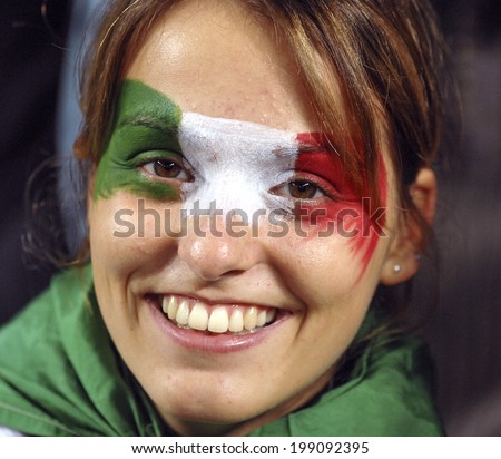 SAINT ETIENNE, FRANCE-SEPTEMBER 30, 2007: italian fan girl with national flag masked face, during the Rugby World Cup match Italy vs Scotland, in Saint Etienne.