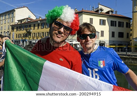 MILAN, ITALY-JUNE 20, 2014: italian soccer fan holding the italian flag watching the Brazil 2014 World Cup football match Italy vs Costa Rica, in Milan.