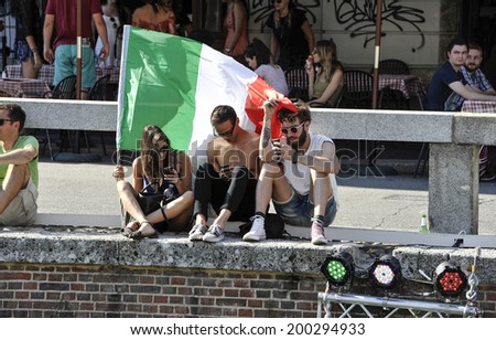 MILAN, ITALY-JUNE 20, 2014: italian fans holding the italian flag during the Brazil 2014 World Cup football match Italy vs Costa Rica, in Milan.